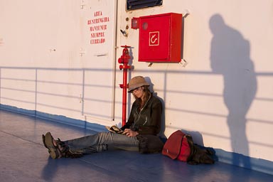 C. reading book on Baja ferry, Shadow is watching.