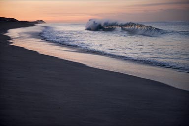 Huge waves pound, Baja California Sur. Sunrise light.