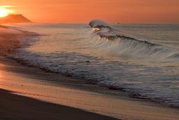 Sunrise  reflected in pounding wave, Baja California Sur. Near Cabo San Jose.