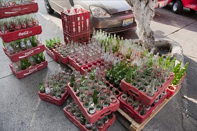 Empty bottles in cases stacked on top of each other, street Guadalajara.