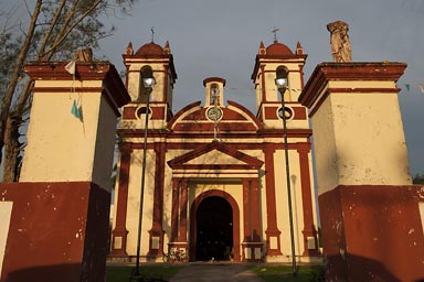 Little red and yellow country church, Samahil, Yucatan, evening light.