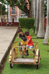 Ticul, boys play with a cart.