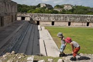 Edzna, Nunnery Quadrangle, twin boys facinated by an Iguana. 