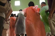 Tourists cramming in small space in visitor's center seeking shelter from rain Chichen Itza.