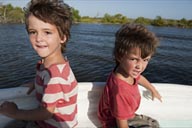 Boys visibly tired from watching birds all morning on a boat trip on Rio Lagartos, Yucatan, Mexico.