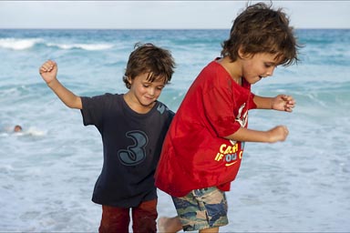 My boys testing the waves in Cancun Beach on evening.