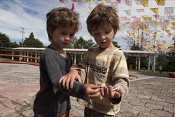 Boys find a white moth. Parking outside San Antonio, San Cristobal de las Casas, Chiapas.