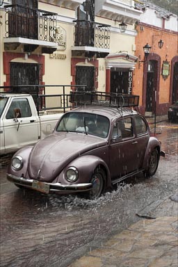 Vochito in heavy rain in calle in San Cristobal de las Casas, Chiapas.