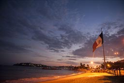 Acapulco beach late, Mexican flag.