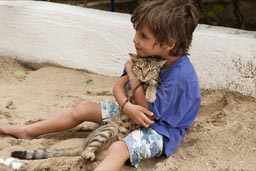 David and his cat in the sand.