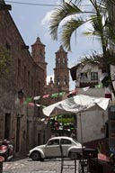 Volkswgen, beetle, street cafe, church in back. Taxco.