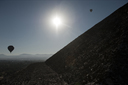 Balloons, sun over Pyramid of the Sun. Teotihuacan, Mexico.