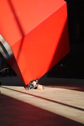 In NY, sun and red cube, financial district.