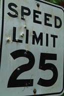 Speed limit sign, bullet pierced.