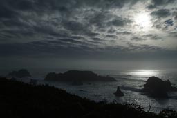 Dark clouds, California cliffs.