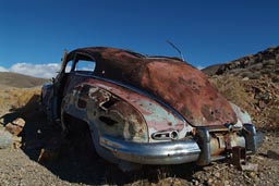 Bullet riddled rusty oldtimer car, near Eureka mine.