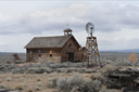 Homestead near Fort Rock, OR. Church and wind wheel.