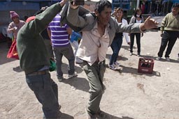 Fiesta Coipasa, men and women dance outdoors, Bolivia. 