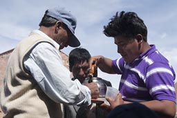 From a teapot, serving schnaps. Coipasa, Bolivia.