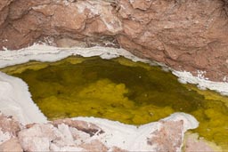 A ditch in the rock full of salty water. Valley de Luna, old salt mines, Atacama.