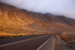 Evening light on desert mountains in the fog, near Paposo, Chile.