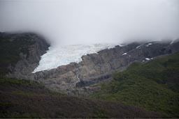 Glaciers and clouds hang deep.