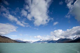 Green glacial waters, snowy mountains, blue skies, O'Higgins lake.