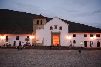 Peak inside the church of Villa de Leyva, on golden altar, Colombia.