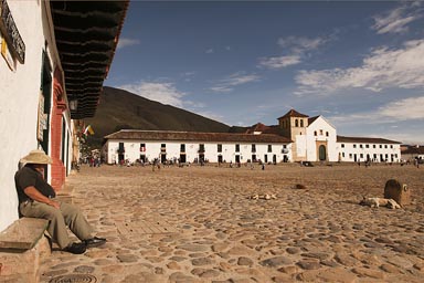 Man on bench tranquillo, main square Villa de Leyva, Colombia.