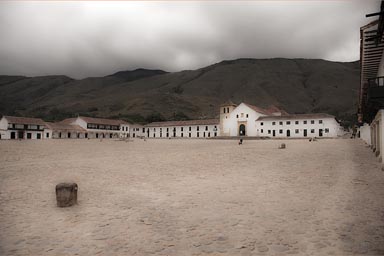 Look at Villa de Leyva main cobbled stone square, empty and cloudy in morning, Colombia.