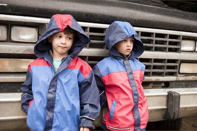 Boys and rain jackets in front of van, Popayan, Colombia.