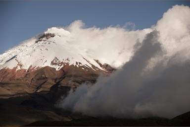 Cotopaxi, snow, clouds, blue sky.