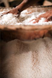 Making of the fine grated yuca, hands feel so soft after, she says. 