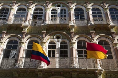 Cuenca, old decorated house, Ecuadorian flag outside.