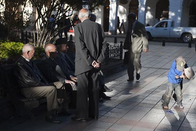 Old men and young boys. Cuenca main plaza.