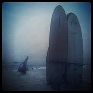 On beach in Montanita, Ecuador, surfbords stand high.