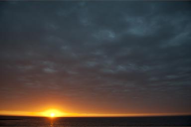 Pacific sunset under a dark cloud. Mancora, Peru.