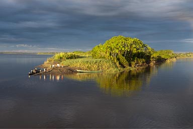 The boat is  slowing down, we ready to land, people wait, Maranon River.