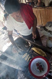 Cocama Cocamilla Nouria prepares rice, platanos, eggs, yuca.