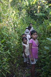 Snakes are everywhere, these children walk barefoot through the mud. Peruvian jungle near Lagunas.