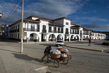 Men pushes cart with baskets, Chapchapoyas, plaza de armas, Peru