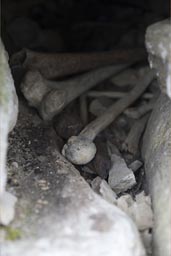 Behind the stones are bones, and the boys discover quickly, ancient burial site in Kuelap, Chachapoyas, Amazonas, Peru.