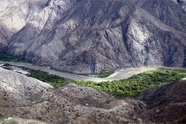 Green lush vegetation of Mangos on Maranon river banks, perched between desert mountains. Border Cajamarca and Amazonas, Peru.