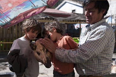 In Chavin, the boys inspect a half grilled pig's head.