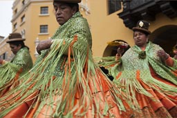 Bollera dresses, green and orange, so beautiful, women from Puno dance and turn on Independence Day, in Lima plaza de armas, Peru.