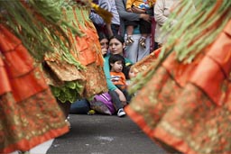 Not just we watch sitting on the pavement, another Peruvian family does the same. Peruvian Independence Day, Lima, p[laza de armas celebrations.