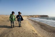 The boys on Yumaque desert cliffs, Paracas National Reserve, Peru.