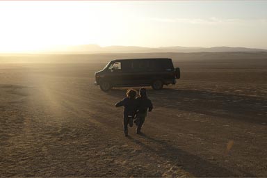 The van and my boys run into late sun and the desert of Paracas, Peru.