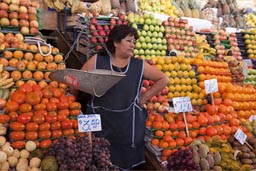 Plenty of fresh fruit in market of Arequipa, women in middle of it, Peru.