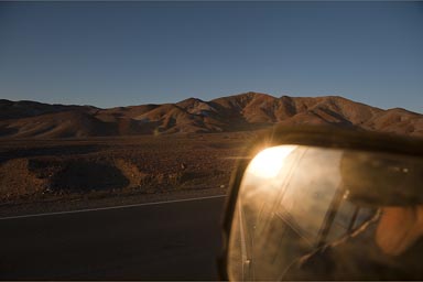 Sun in mirror, sunset is near, desert mountains near Arequipa, Peru.